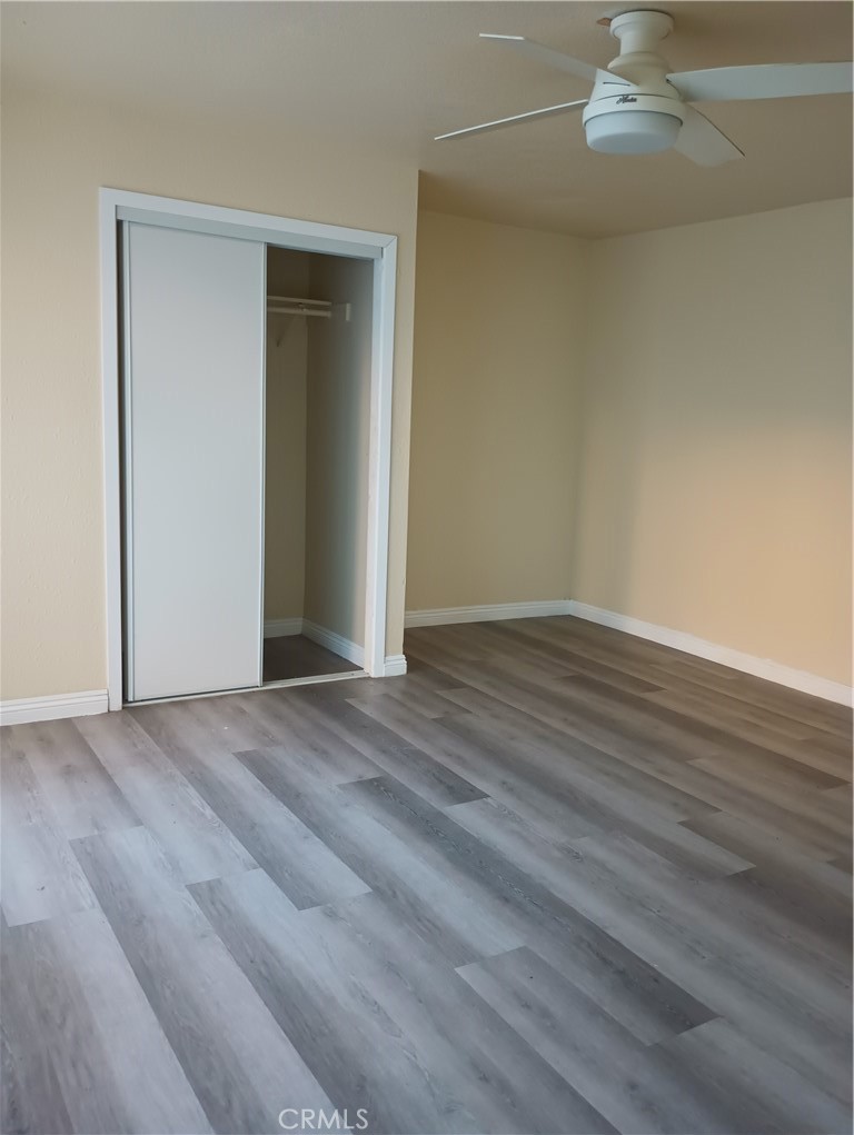 648 Abbey Lane Pomona, CA 91767 - Photo 4 of 6 a view of an empty room with wooden floor and a window