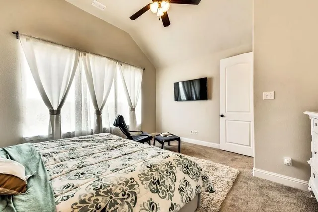 a bedroom with a bed and a large window