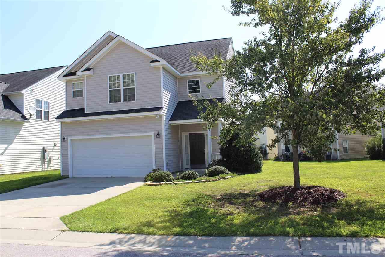 8518 Boysenberry Lane Raleigh, NC 27616 - Photo 1 of 17 a front view of a house with a yard and garage