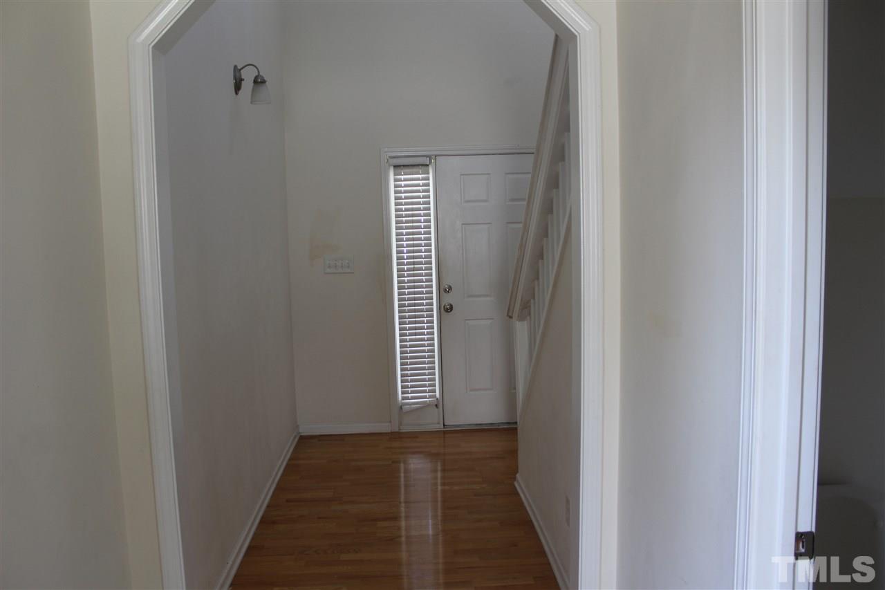 8518 Boysenberry Lane Raleigh, NC 27616 - Photo 12 of 17 a view of a hallway with wooden floor