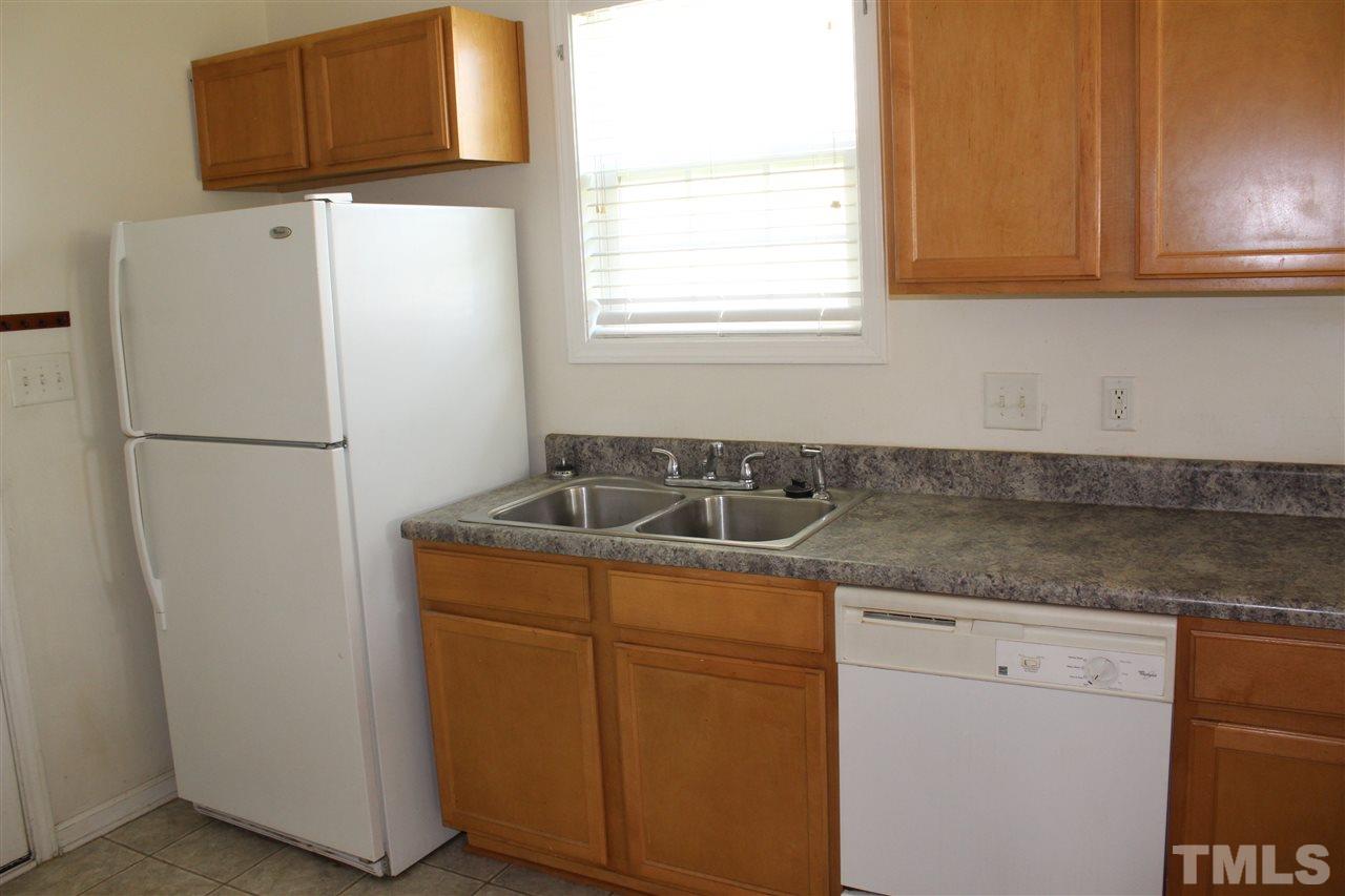 8518 Boysenberry Lane Raleigh, NC 27616 - Photo 15 of 17 a utility room with cabinets washer and dryer