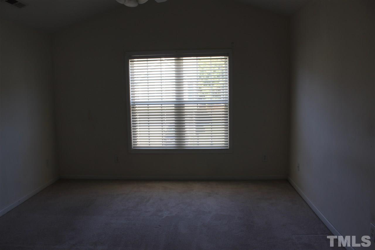 8518 Boysenberry Lane Raleigh, NC 27616 - Photo 6 of 17 an empty room with a window