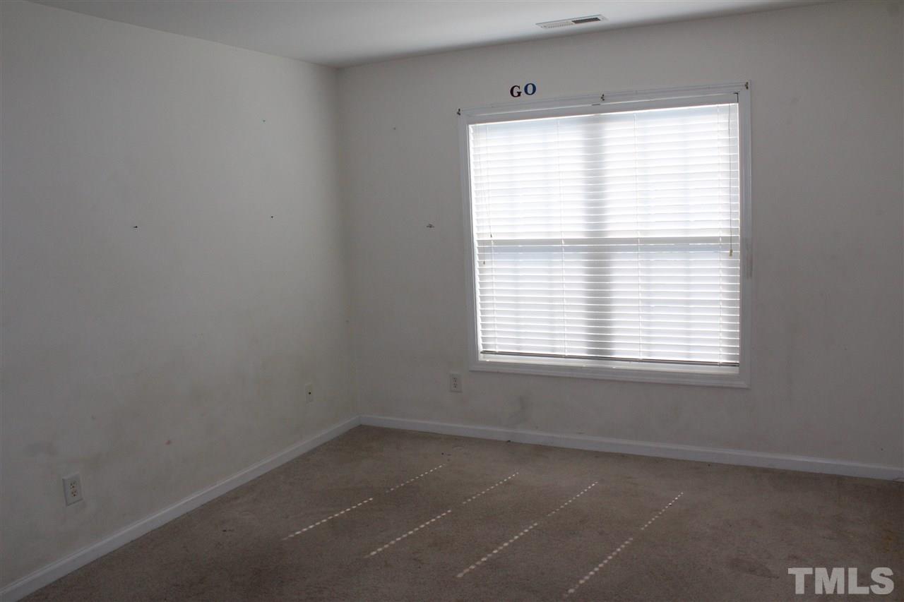 8518 Boysenberry Lane Raleigh, NC 27616 - Photo 8 of 17 an empty room with a window