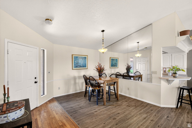 161 West 950 South, Unit Q1 St. George, UT 84770 - Photo 6 of 37 Dining space with dark wood-style flooring and vaulted ceiling