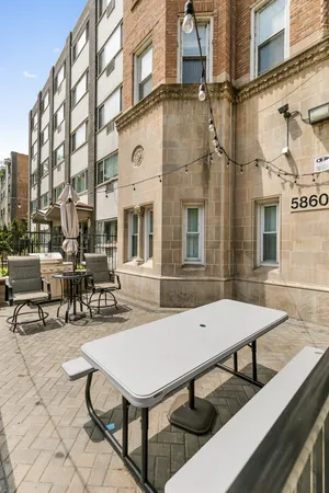 a view of a building with sitting area