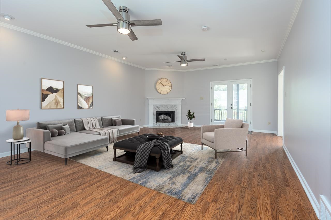 3358 Bailey Station Road Collierville, TN 38017 - Photo 10 of 31 Living room featuring hardwood / wood-style flooring, ceiling fan, crown molding, and a premium fireplace