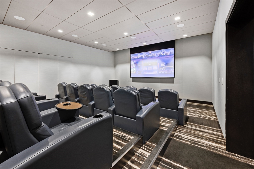 1 Franklin Street, Unit 1002 Boston, MA 02110 - Photo 15 of 21 a media room with lots of chairs and a projector screen
