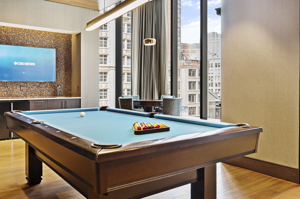 1 Franklin Street, Unit 1002 Boston, MA 02110 - Photo 17 of 21 a room with pool table and windows