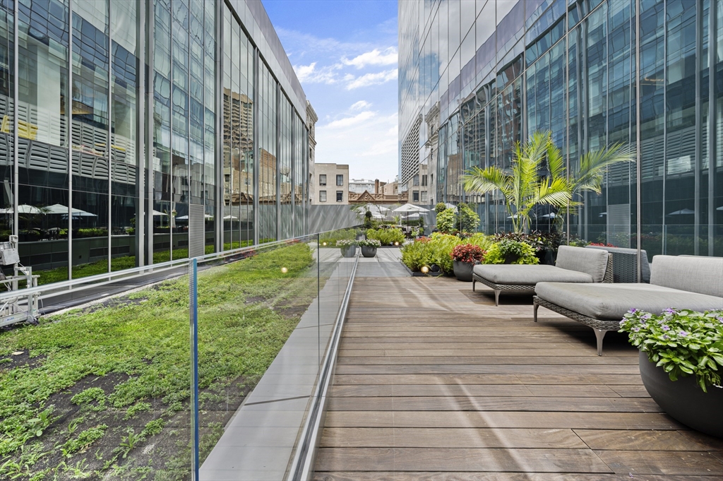 1 Franklin Street, Unit 1002 Boston, MA 02110 - Photo 21 of 21 a view of a building with sitting area and garden