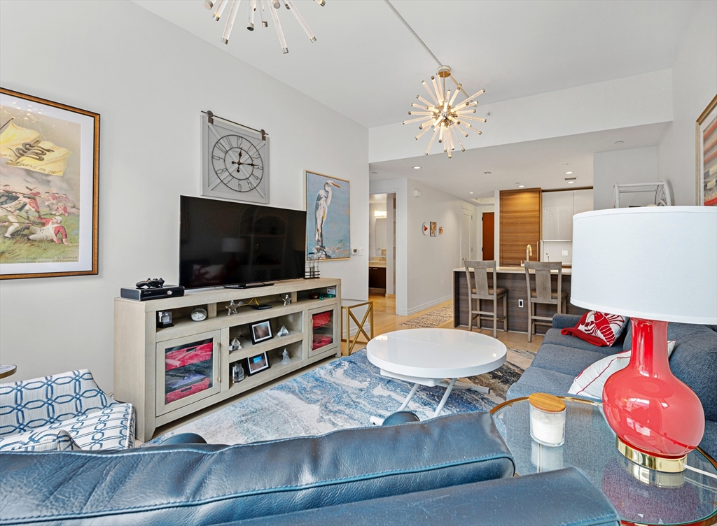 1 Franklin Street, Unit 1002 Boston, MA 02110 - Photo 4 of 21 a living room with furniture and a flat screen tv