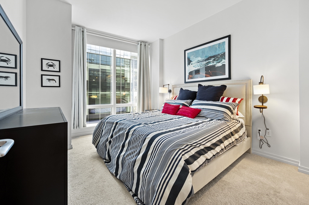 1 Franklin Street, Unit 1002 Boston, MA 02110 - Photo 6 of 21 a bedroom with a bed and a desk