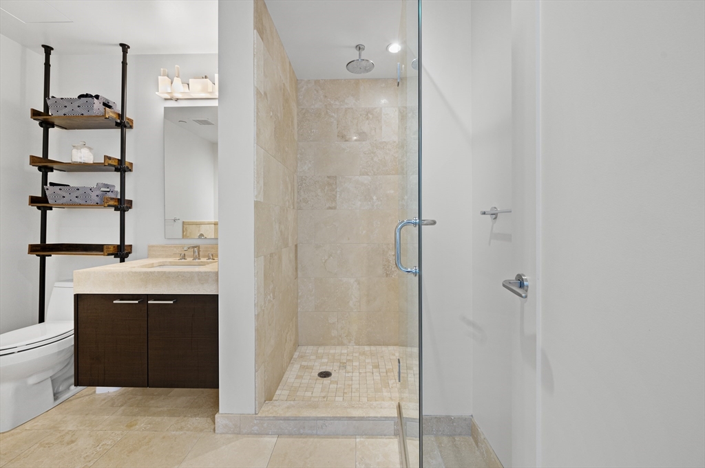 1 Franklin Street, Unit 1002 Boston, MA 02110 - Photo 8 of 21 a bathroom with a bathtub and a sink