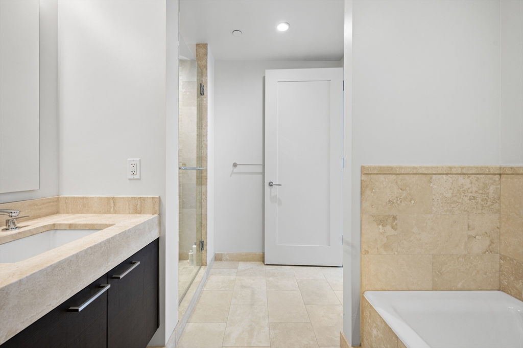 1 Franklin Street, Unit 1002 Boston, MA 02110 - Photo 10 of 21 a bathroom with a sink a toilet and shower