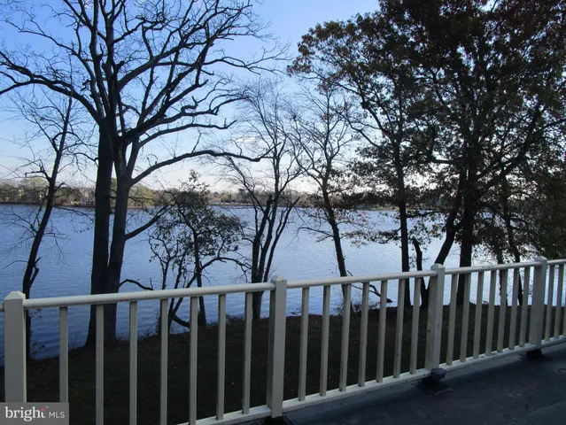 a view of staircase with railing and white walls