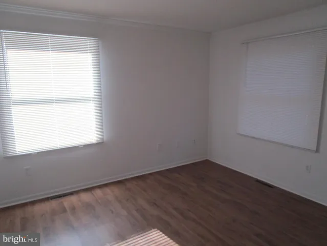 a kitchen with stainless steel appliances granite countertop white cabinets a stove a sink and dishwasher