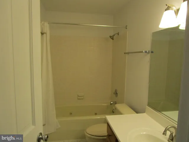a kitchen with granite countertop white cabinets stainless steel appliances and a sink