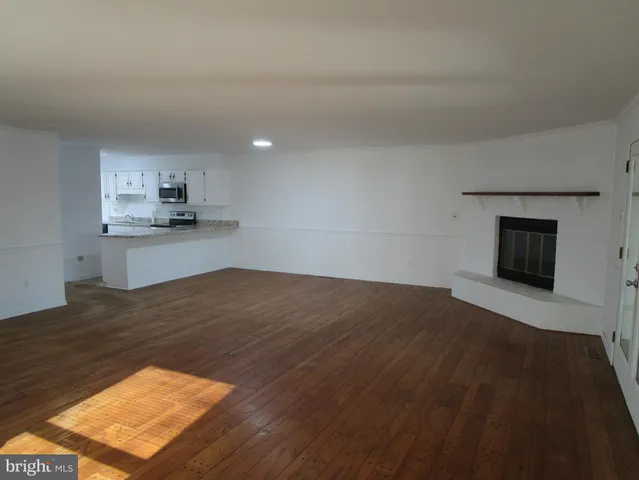 a kitchen with granite countertop white cabinets and a sink