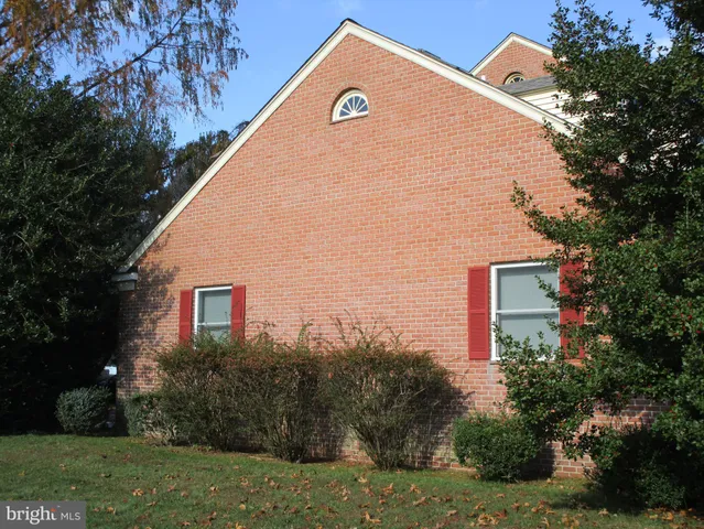 a kitchen with stainless steel appliances granite countertop a sink a stove a microwave a sink and white cabinets