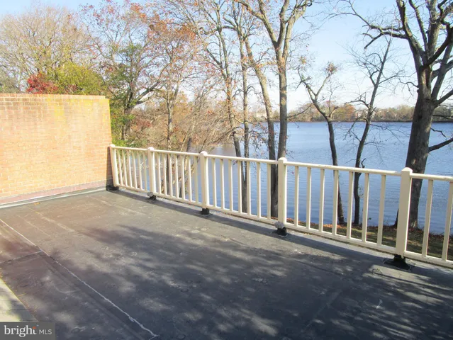 a view of balcony with wooden floor and fence