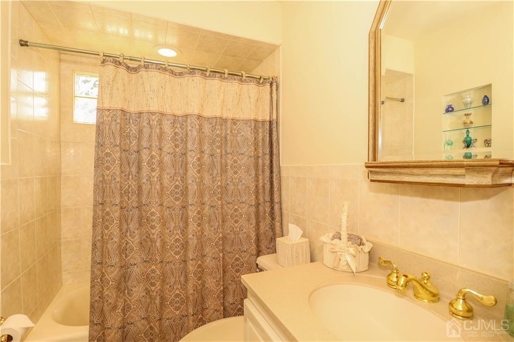 9 Meyer Road Edison, NJ 08817 - Photo 20 of 32 a bathroom with a sink and a mirror