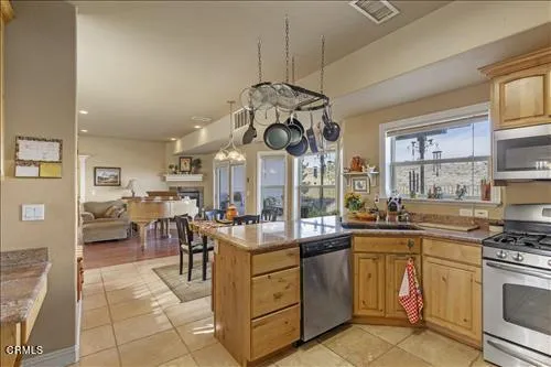 a kitchen with a sink a stove and cabinets