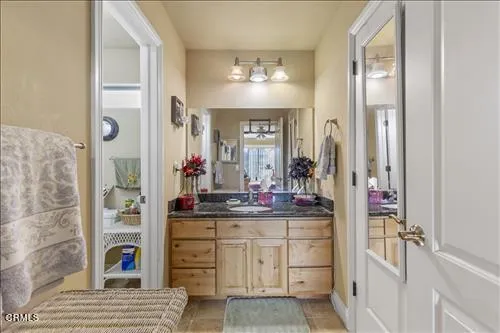 a bed room with a bed and a chair