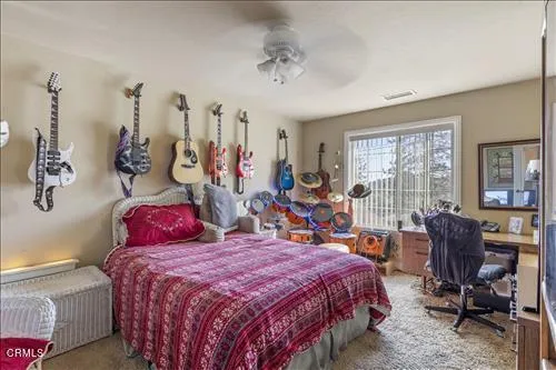 a bed room with a bed mirror and a window