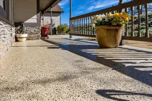 a view of a house with backyard sitting area and garden