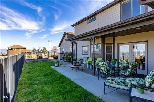 a view of a patio with chairs and a table
