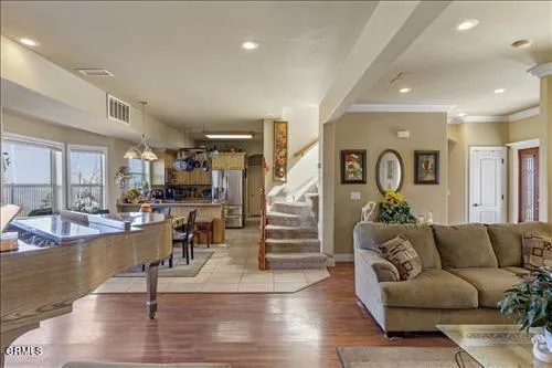 a living room with fireplace furniture and wooden floor