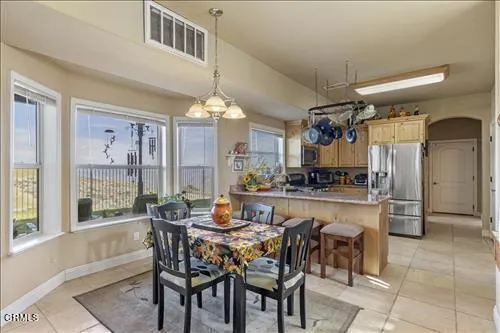 a dining area with a table and chairs