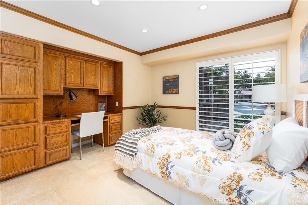 23 Flores, Unit 19 Irvine, CA 92612 - Photo 23 of 37 a bedroom with a bed and wooden floor