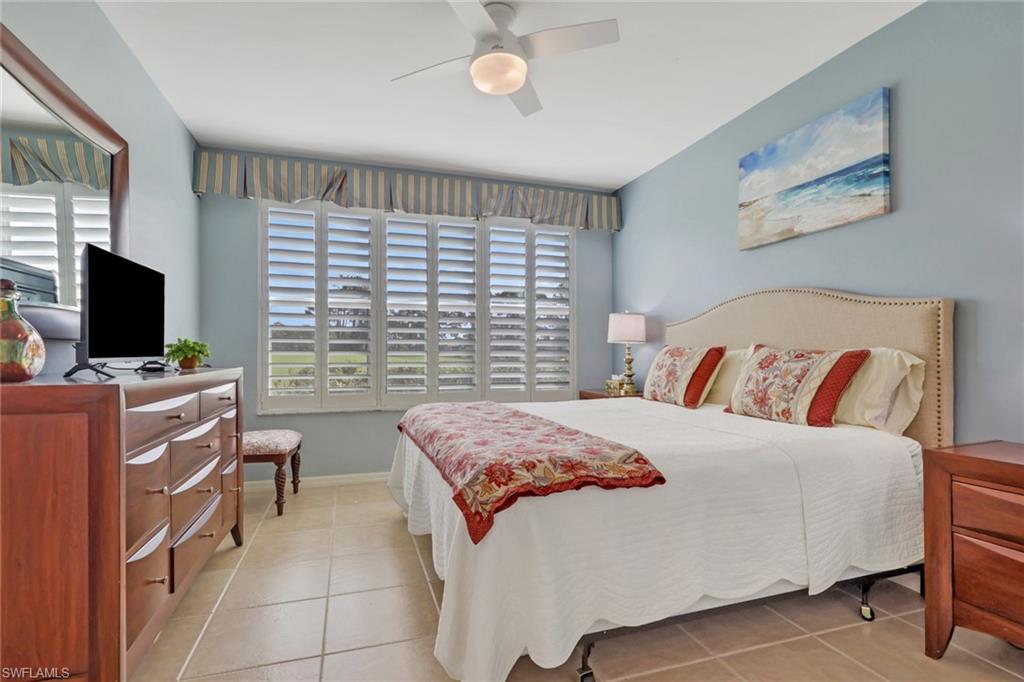 9281 Spring Run Boulevard, Unit 2607 Estero, FL 34135 - Photo 18 of 32 a bedroom with a bed and a flat screen tv