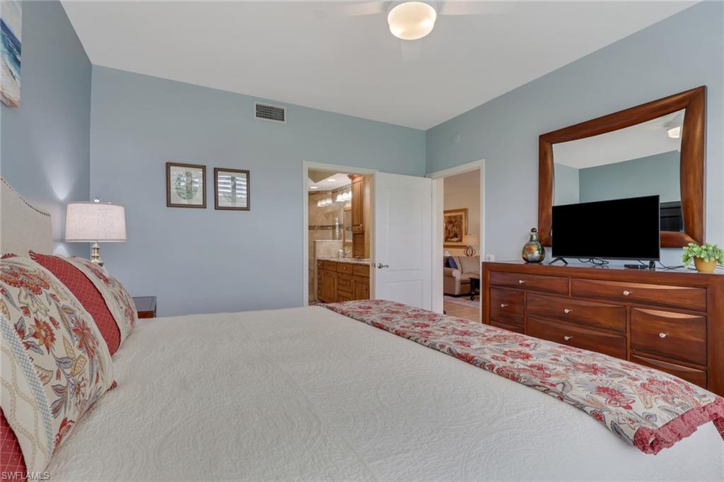 9281 Spring Run Boulevard, Unit 2607 Estero, FL 34135 - Photo 19 of 32 a bedroom with a bed and a flat screen tv