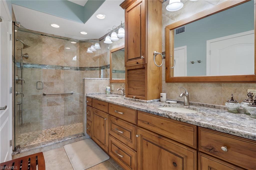 9281 Spring Run Boulevard, Unit 2607 Estero, FL 34135 - Photo 20 of 32 a bathroom with a granite countertop sink mirror and double