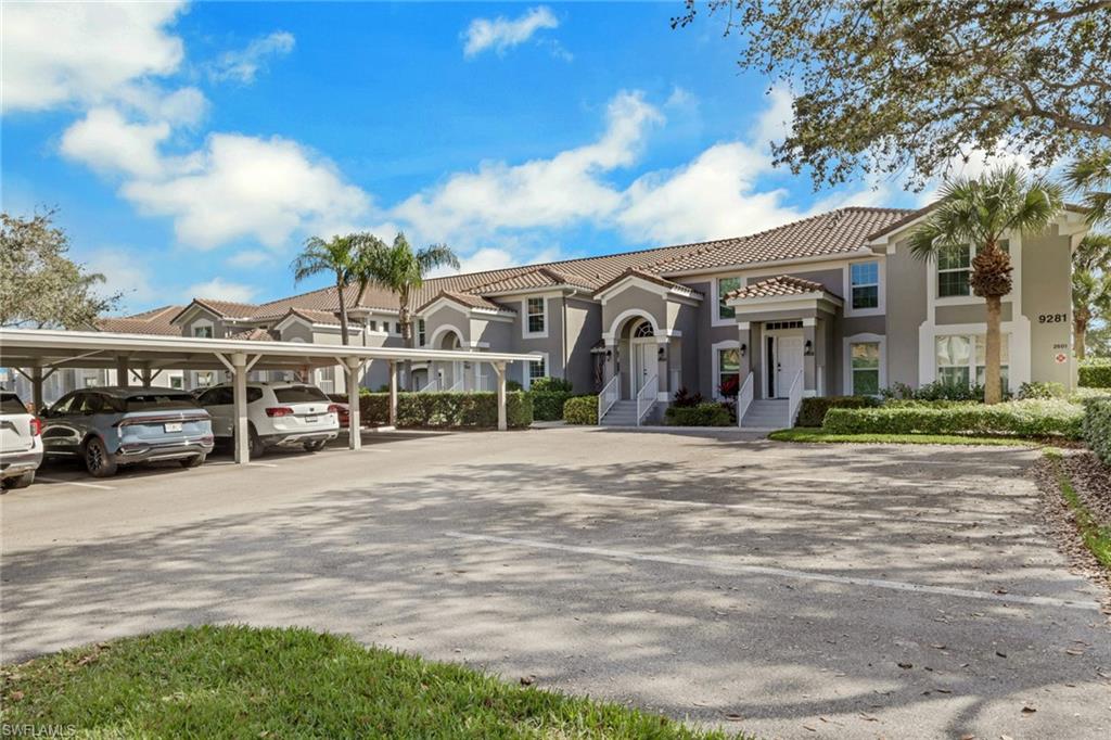 9281 Spring Run Boulevard, Unit 2607 Estero, FL 34135 - Photo 2 of 32 a view of a building with a yard