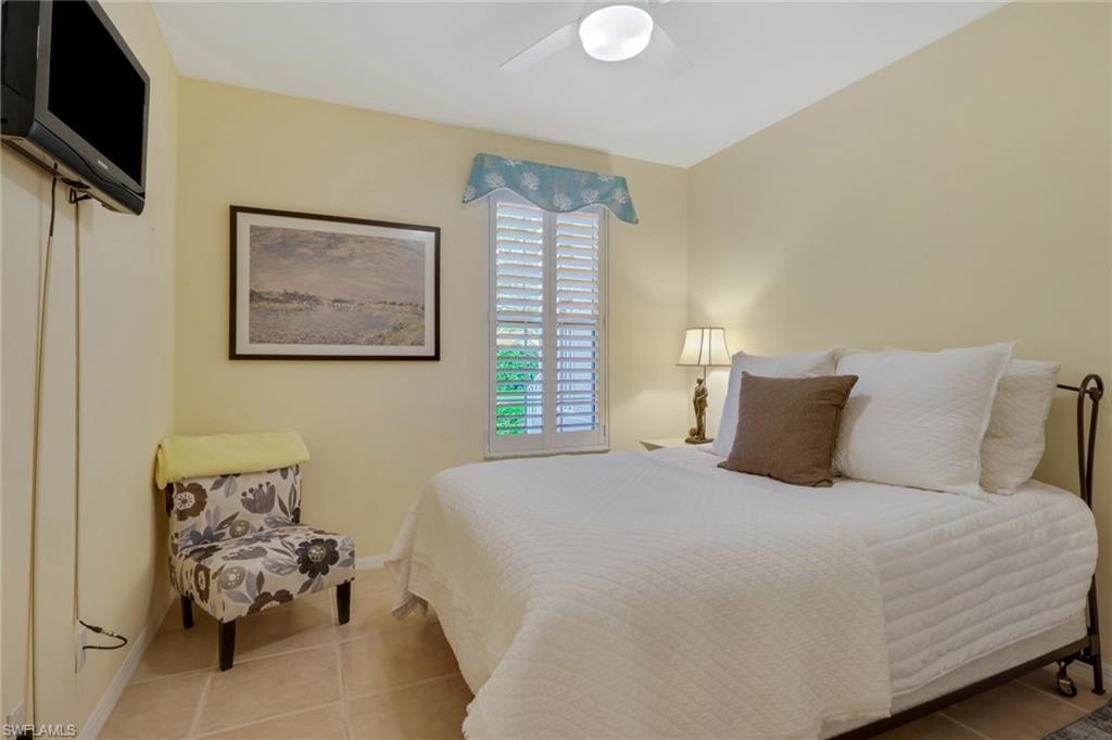 9281 Spring Run Boulevard, Unit 2607 Estero, FL 34135 - Photo 22 of 32 a bedroom with a bed and furniture