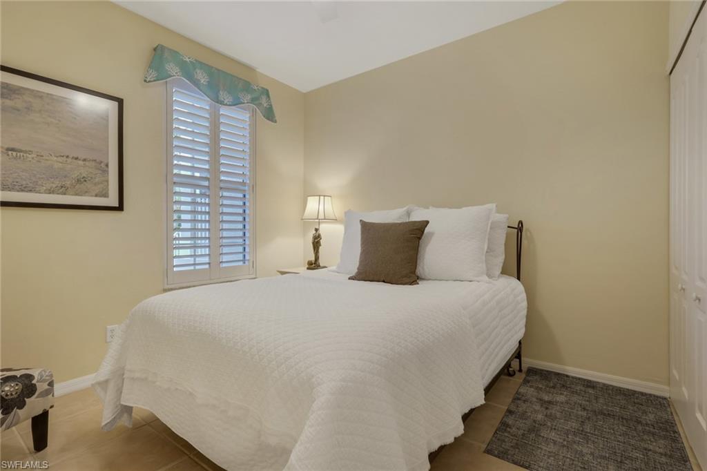9281 Spring Run Boulevard, Unit 2607 Estero, FL 34135 - Photo 23 of 32 a bedroom with a bed and a window