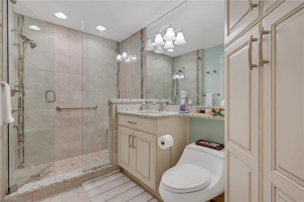 9281 Spring Run Boulevard, Unit 2607 Estero, FL 34135 - Photo 25 of 32 a bathroom with a sink a toilet and shower