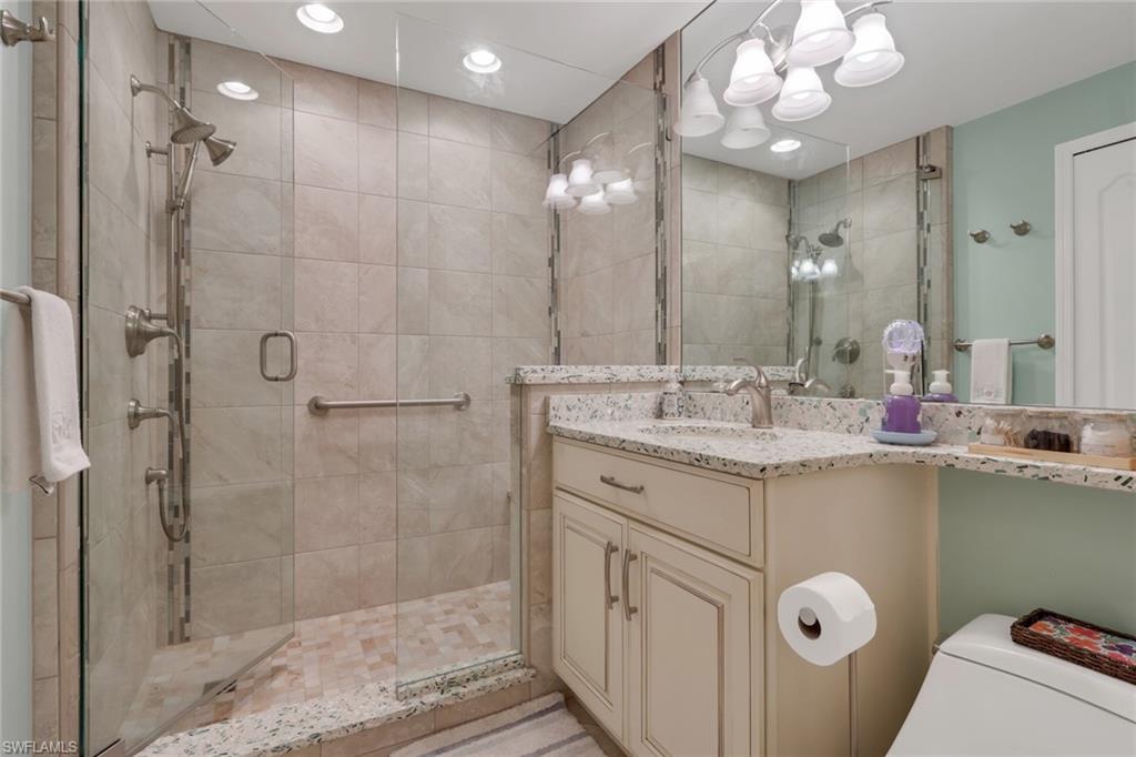 9281 Spring Run Boulevard, Unit 2607 Estero, FL 34135 - Photo 26 of 32 a bathroom with a sink shower and a mirror