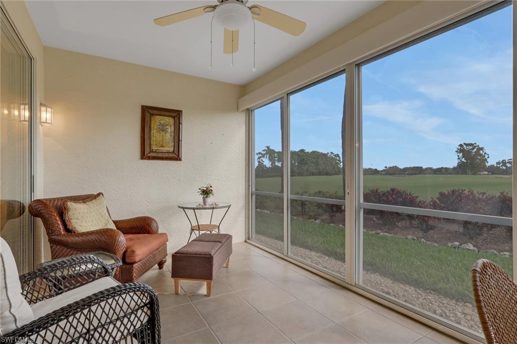 9281 Spring Run Boulevard, Unit 2607 Estero, FL 34135 - Photo 27 of 32 a balcony with furniture and a floor to ceiling window