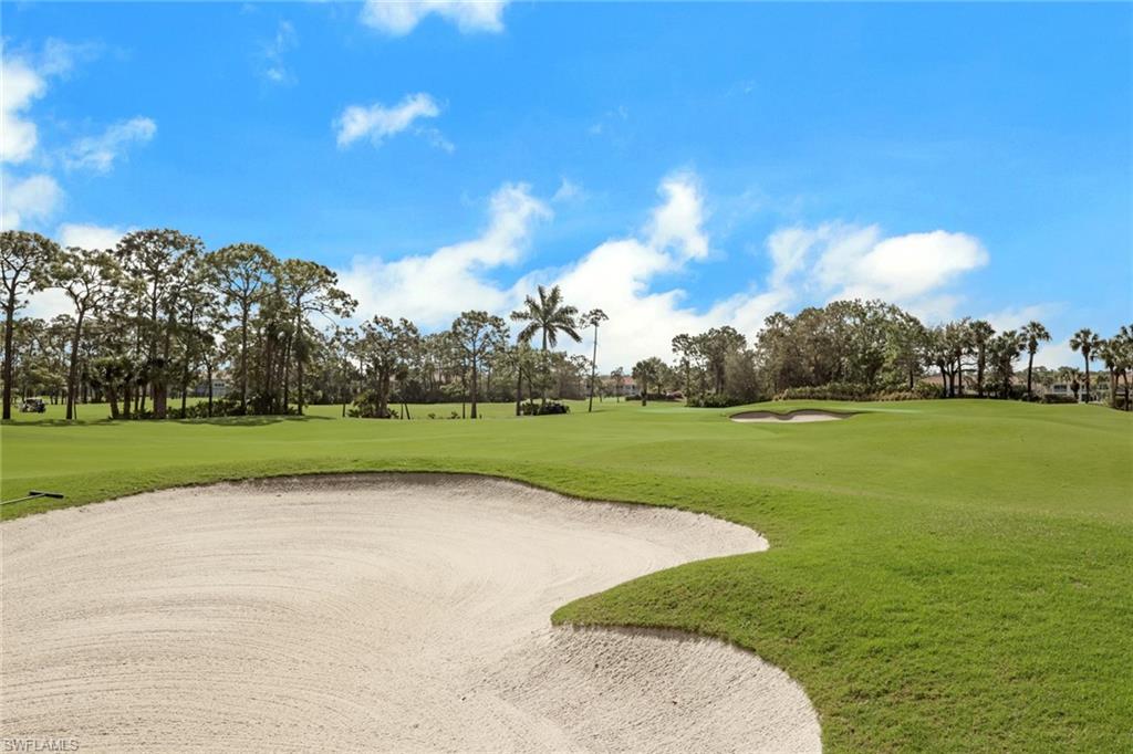 9281 Spring Run Boulevard, Unit 2607 Estero, FL 34135 - Photo 31 of 32 a view of a golf course with a lake