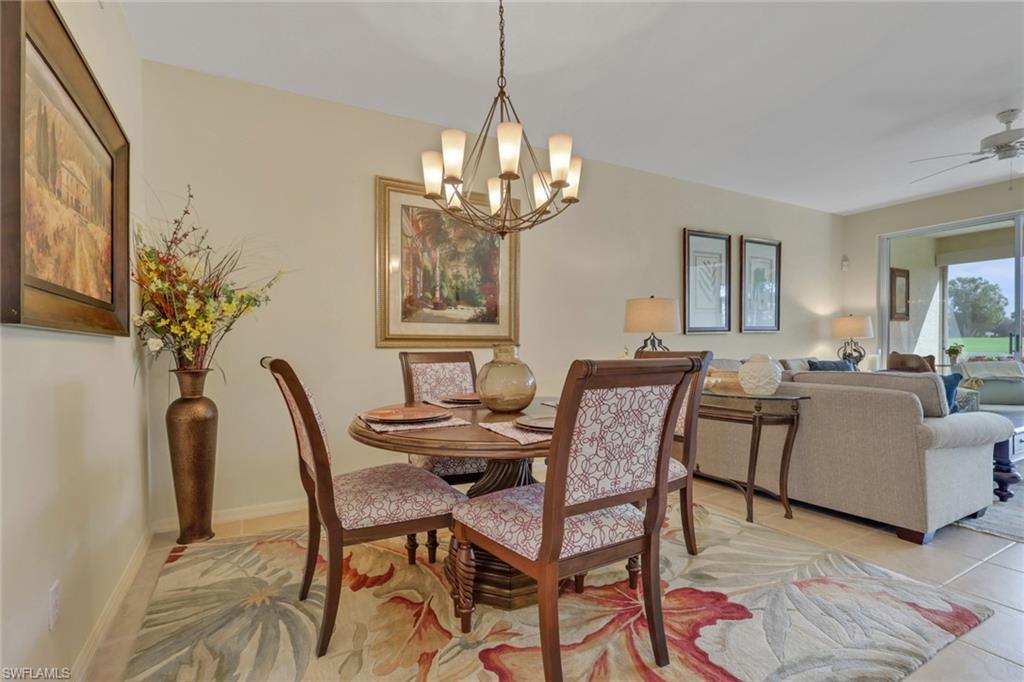 9281 Spring Run Boulevard, Unit 2607 Estero, FL 34135 - Photo 10 of 32 a view of a dining room with furniture and chandelier
