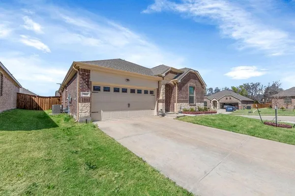 a view of a big house with a big yard and large tree