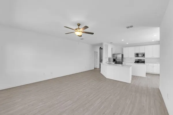 a view of kitchen with furniture and wooden floor