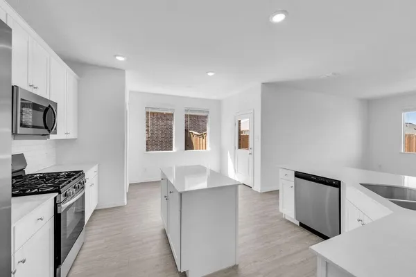 a kitchen with sink and cabinets