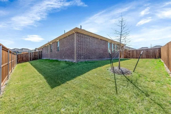 a house view with a play ground in front of it