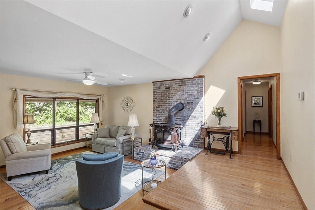 23 Pingree Farm Road Georgetown, MA 01833 - Photo 9 of 30 a living room with furniture a fireplace and a table