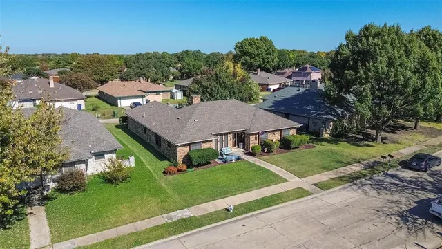 an aerial view of a house with a yard