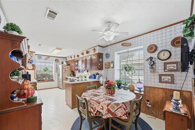a view of a dining room and livingroom with furniture wooden floor and a clock